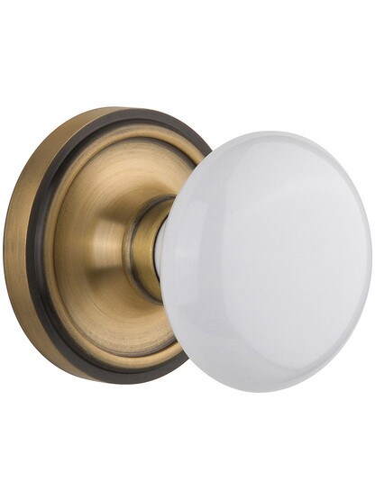 Classic Rosette Door Set With White Porcelain Door Knobs Single Dummy in Antique Brass.